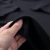 pauljoystick_black_oversized_t-shirt_fabric_held_between_fing_b62df1a3-9b4f-4302-aa77-453fab87ec17_0.png